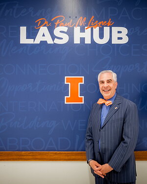 Paul Lisnek poses in front of the entrance to the Dr. Paul M. Lisnek LAS Hub