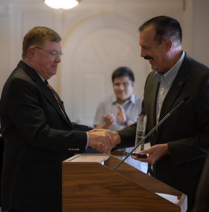 michael mcdonald receives alumni award at a ceremony