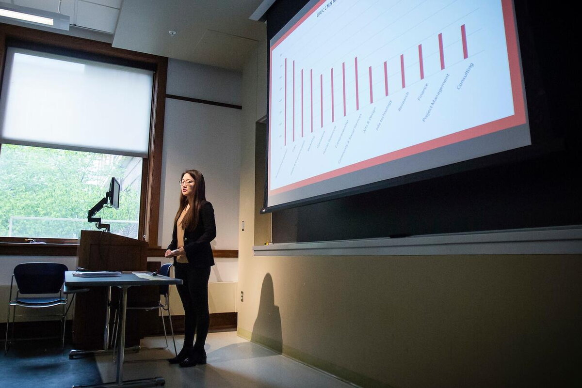 Female student gives a careers presentation in communication department class.