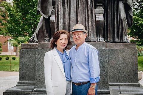 Max and Bonnie Kim pose near the Alma Mater statue