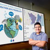 Joseph Trujillo-Falcon standing in front of a screen displaying study graphics