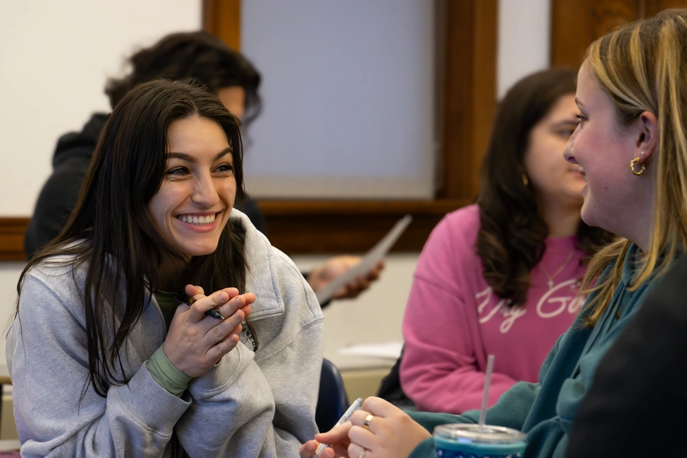 students talking and grinning during a class activity