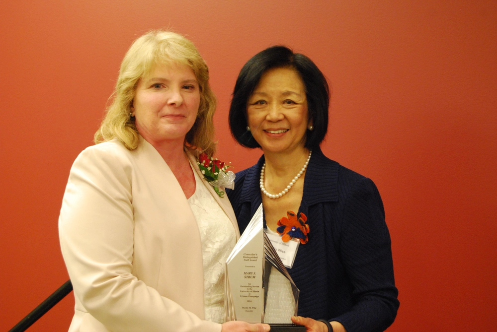 Barbara Hall receives an award from the chancellor
