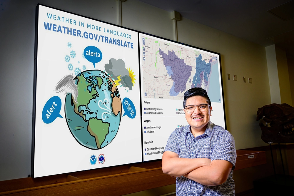 Joseph Trujillo-Falcon standing in front of a screen displaying study graphics