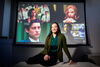 Mustafaj sits in front of a screen displaying films used in her study